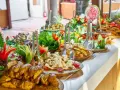 Buffet con patate arrosto, insalate fresche e frutta intagliata. Ecco come mettere la tovaglia per buffet, creando un'atmosfera invitante.