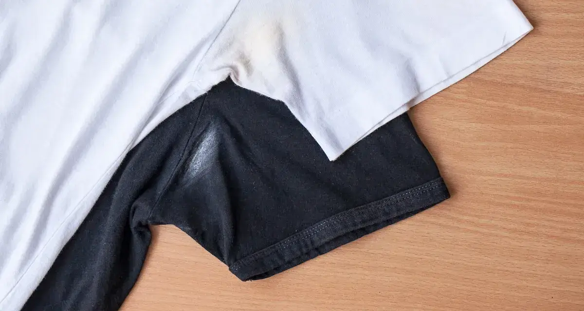 Yellow underarm stains on a white t-shirt and a white residue on a black t-shirt.