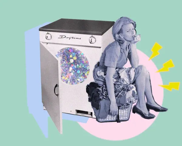 Donna annoiata seduta su un cesto di panni, accanto a una lavatrice con glitter. Un'idea su come disinfettare i vestiti senza lavarli.